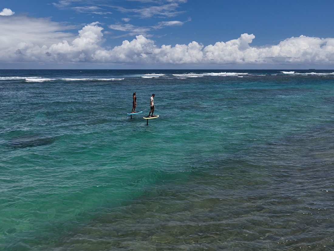 Two people eFoiling on the water