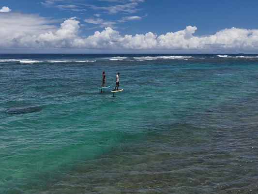 Two people eFoiling on the water